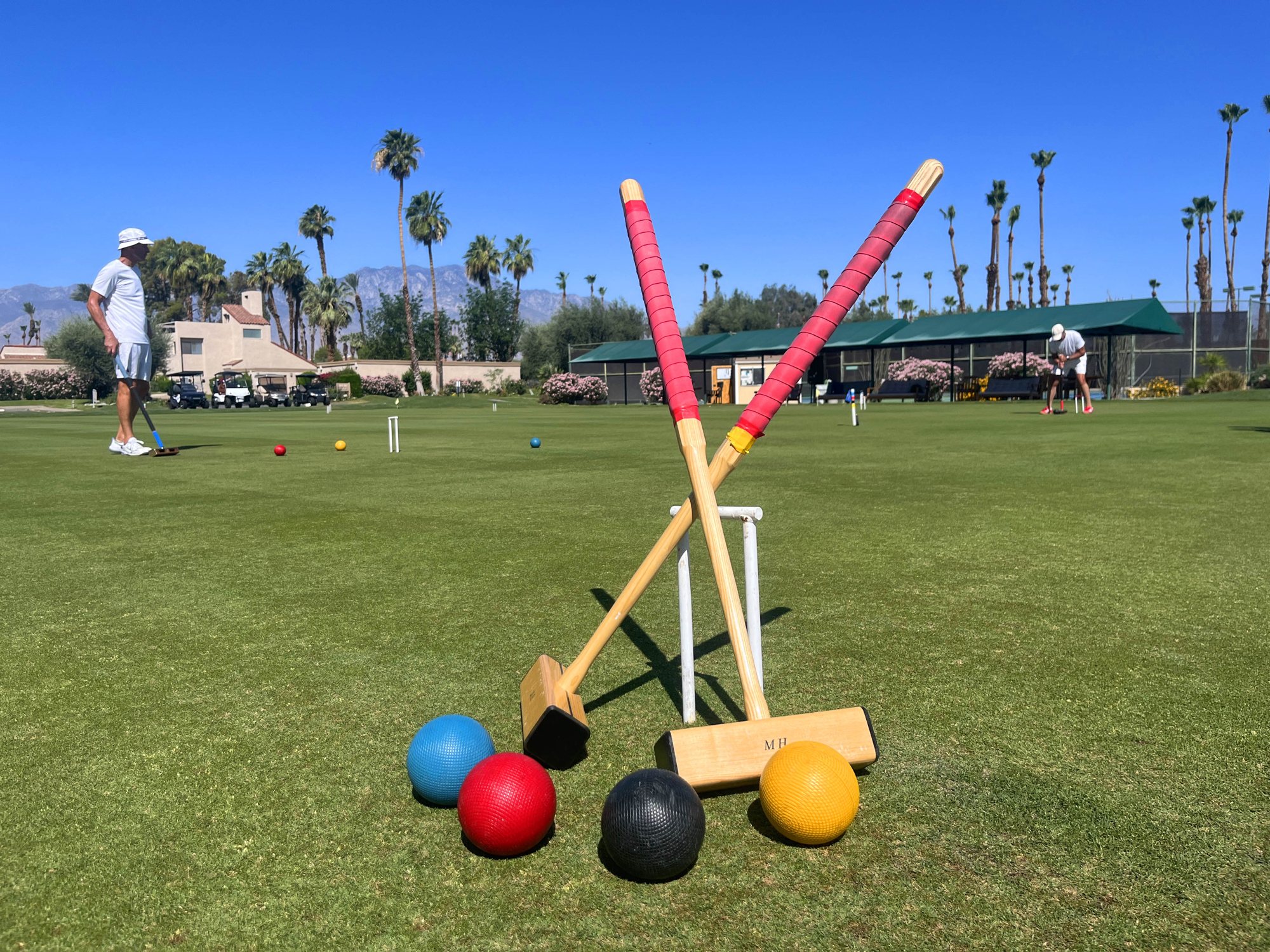Mallets and balls on the Mission Hills lawn with the mountains beyond