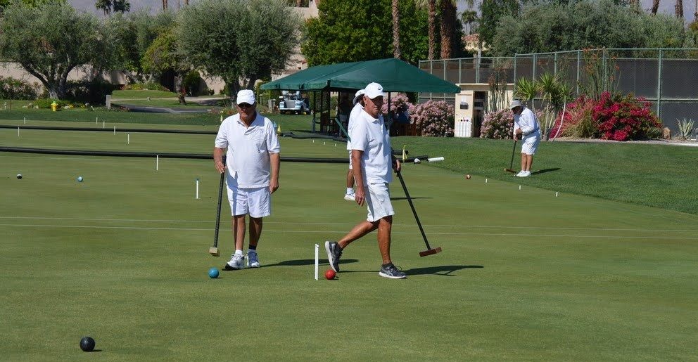 Two players mid-match on the lawn
